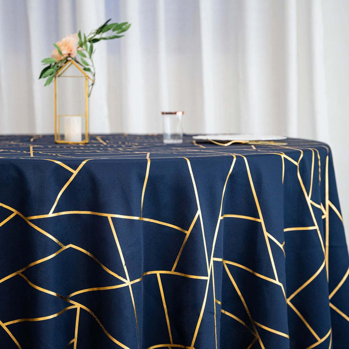 Navy tablecloth with gold geometric design on a styled table setting.
