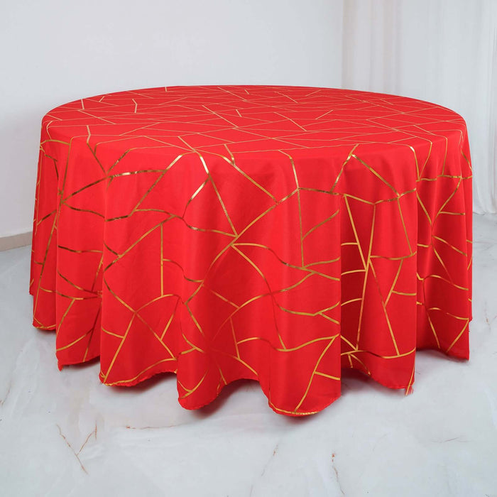 Red tablecloth with a gold geometric pattern on a round surface.