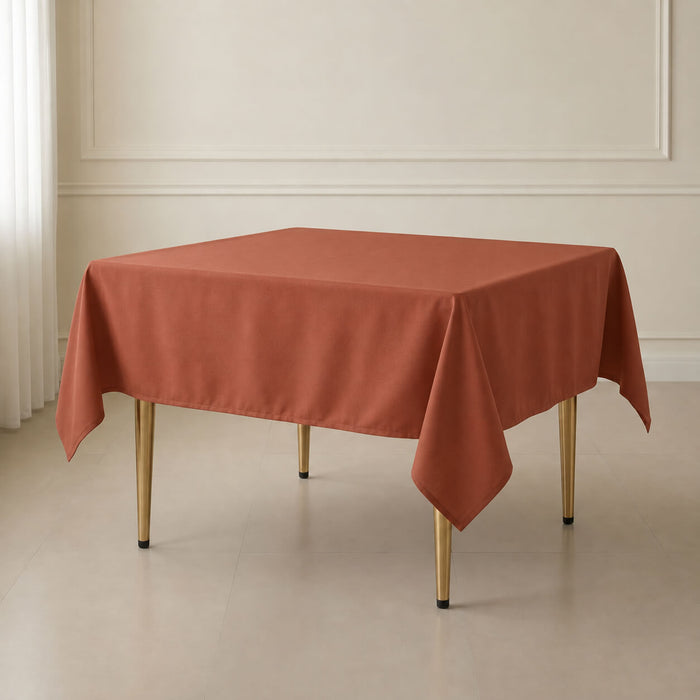 Terracotta wrinkle-resistant square tablecloth on a table.