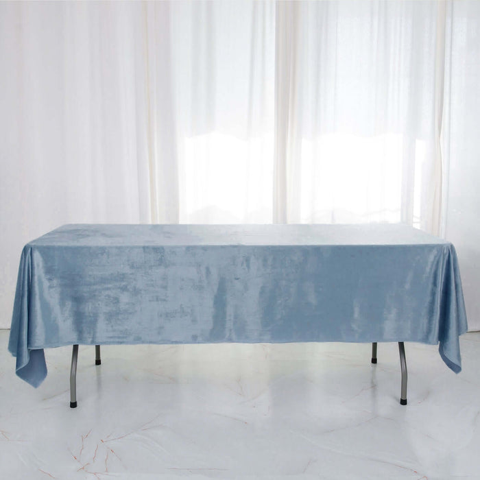 Blue velvet tablecloth draped over a table in a bright, airy setting.
