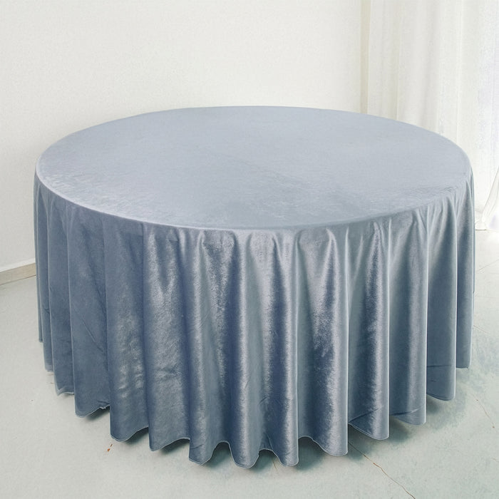 Round blue velvet tablecloth with elegant draping.