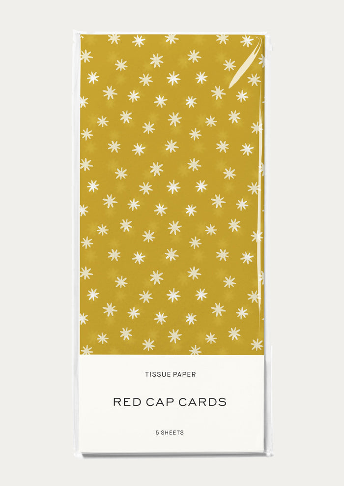 Tissue paper packaging with yellow and white star pattern on a white background