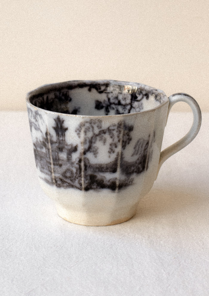 Ceramic mug with black pattern on a white surface