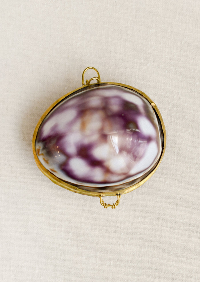 A purple cowrie shell trinket box.