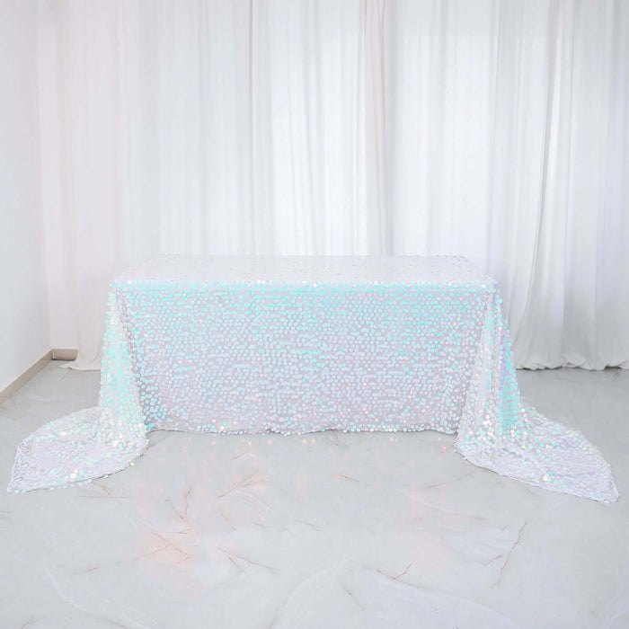 Iridescent sequin tablecloth on a white table against a plain backdrop