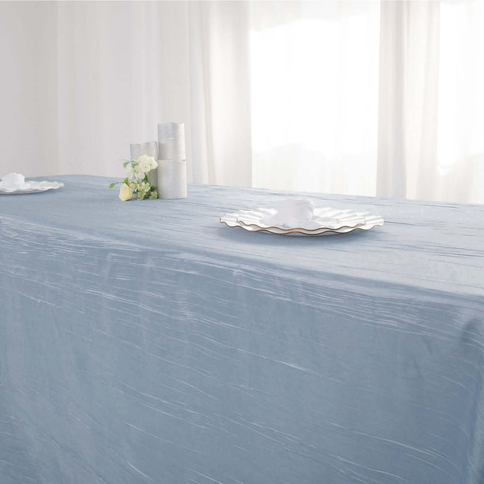 Elegant light blue tablecloth draped on a table with decorative plates.