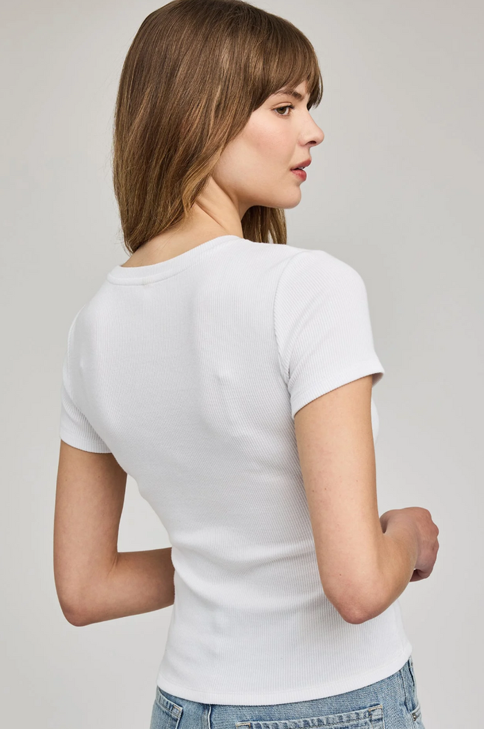 Woman wearing a plain white t-shirt against a light gray background