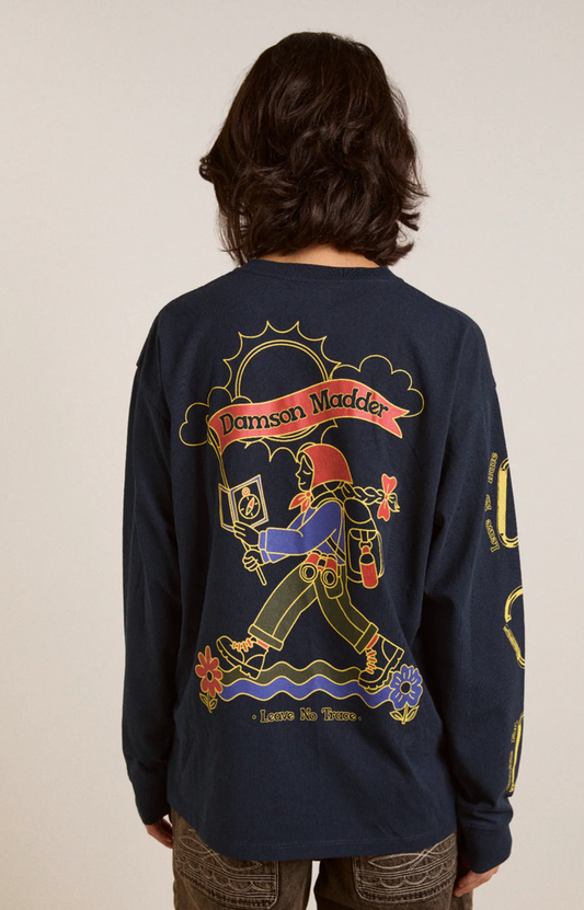 Person wearing a navy blue long-sleeve shirt with colorful graphics and text on the back.
