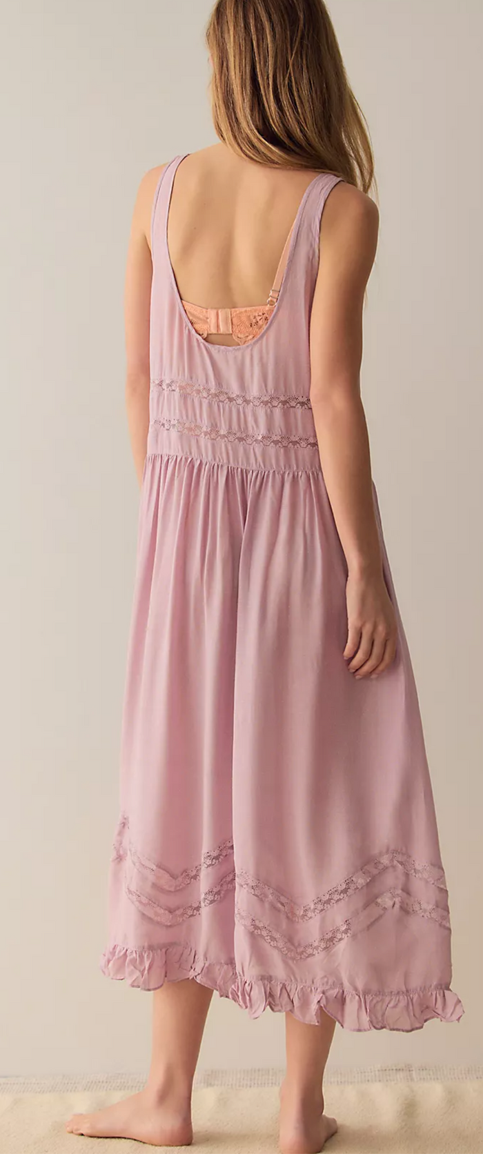 Lilac dress with lace details on a plain background