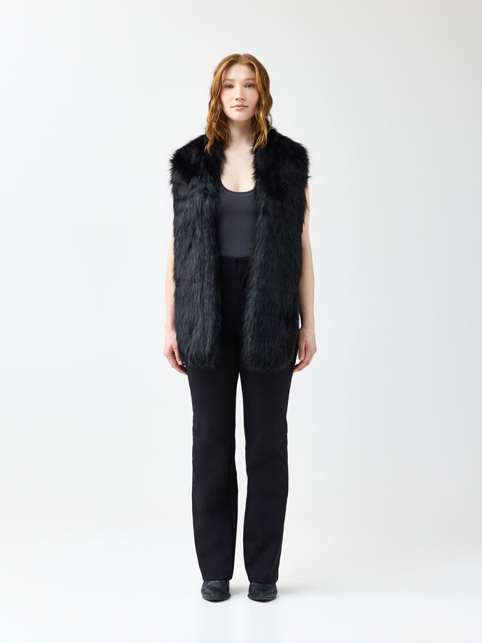 Woman wearing a black faux fur scarf on a white background