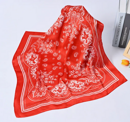 Red bandana with white patterns on a light gray background