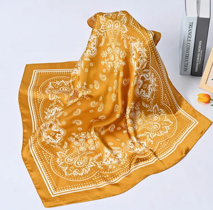 Yellow bandana with white patterns on a white background