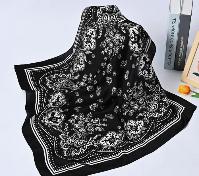 Black bandana with white patterns on a light gray background