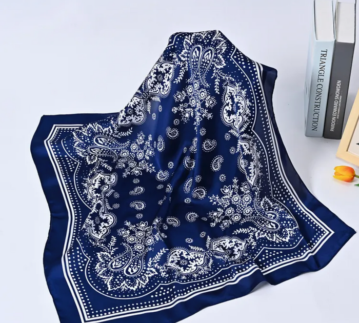 Blue bandana with white patterns on a light gray background