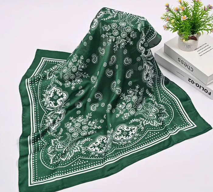 Green bandana with white patterns on a white surface