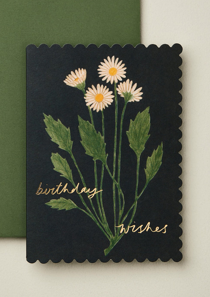 Black card with white flowers and 'birthday wishes' text on a green background