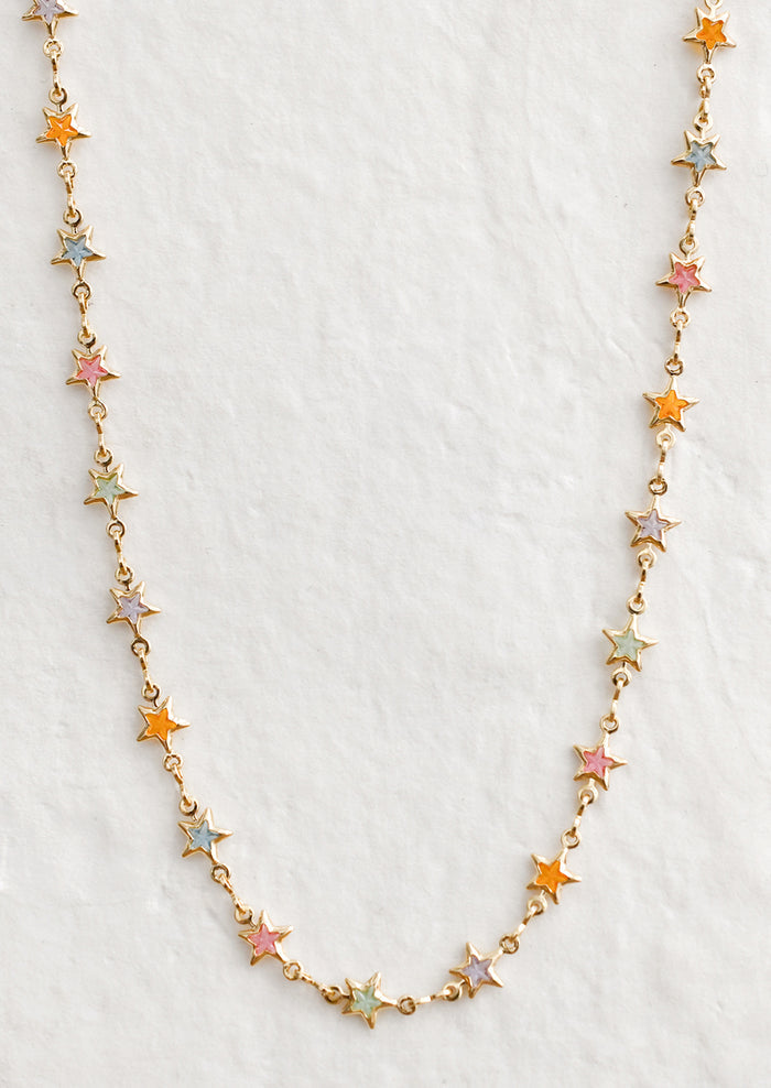 A gold necklace with multicolor pastel star stations.