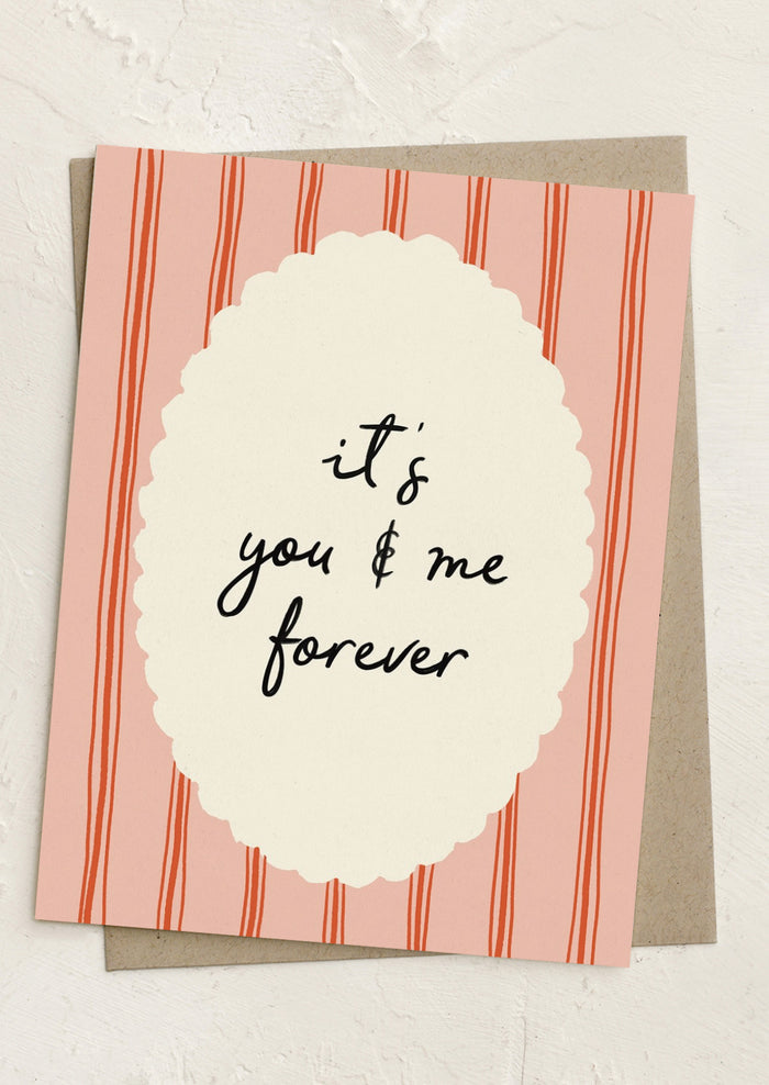 A greeting card with framed text reading "It's you and me forever".